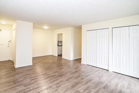 A room with white doors and a wooden floor.
