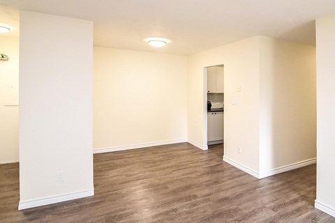 A room with wooden floors and white walls.