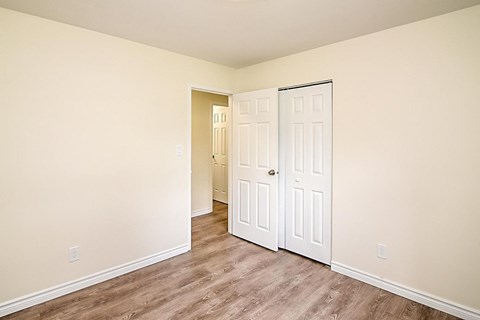 A room with a white door and a white wall.