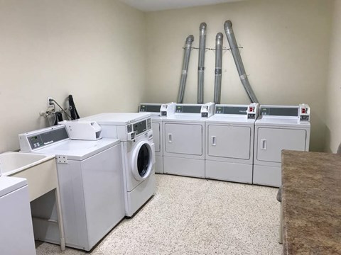 A laundry room with washers and dryers.