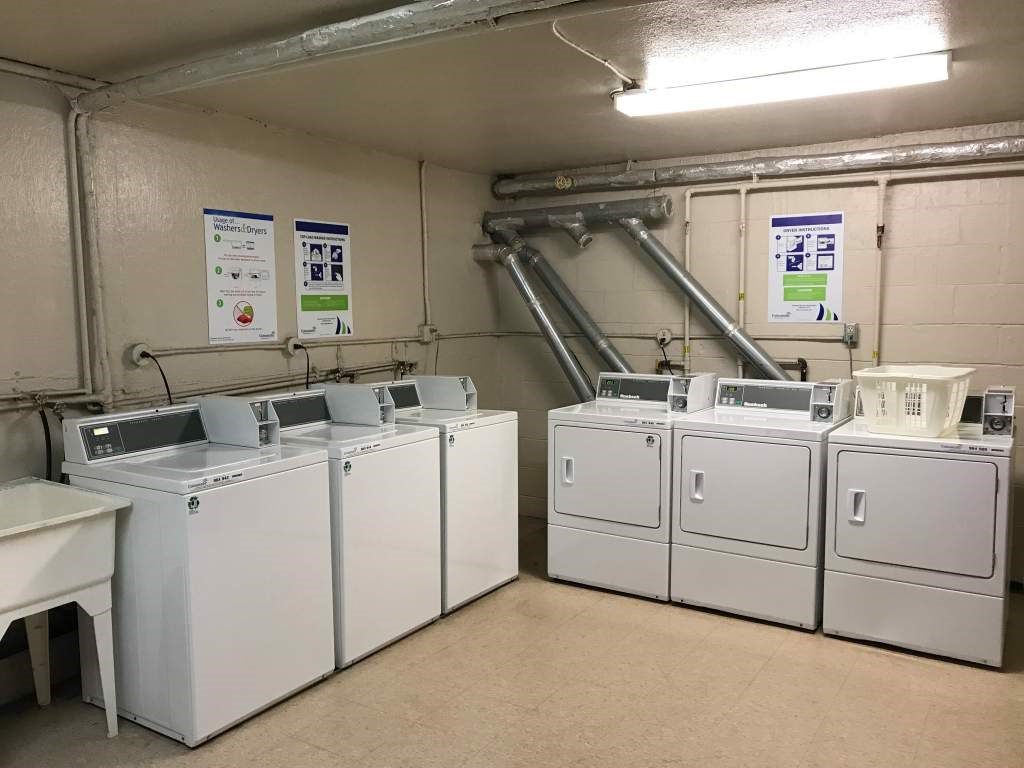 A laundry room with washers and dryers.