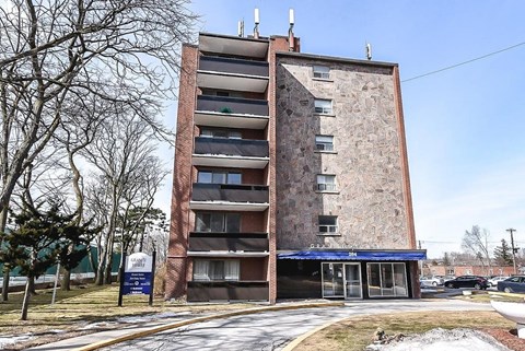 A tall brick building with a blue awning and a sign that reads "FANNY'S".