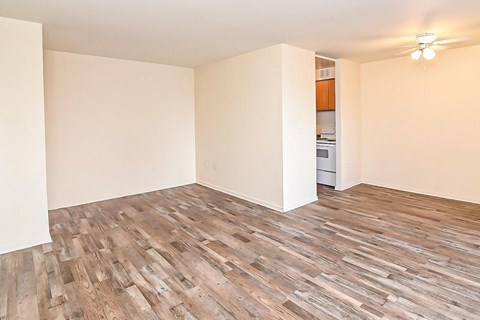 A room with wooden flooring and a ceiling fan.