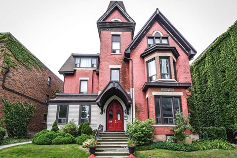 A red brick house with a grey front door.