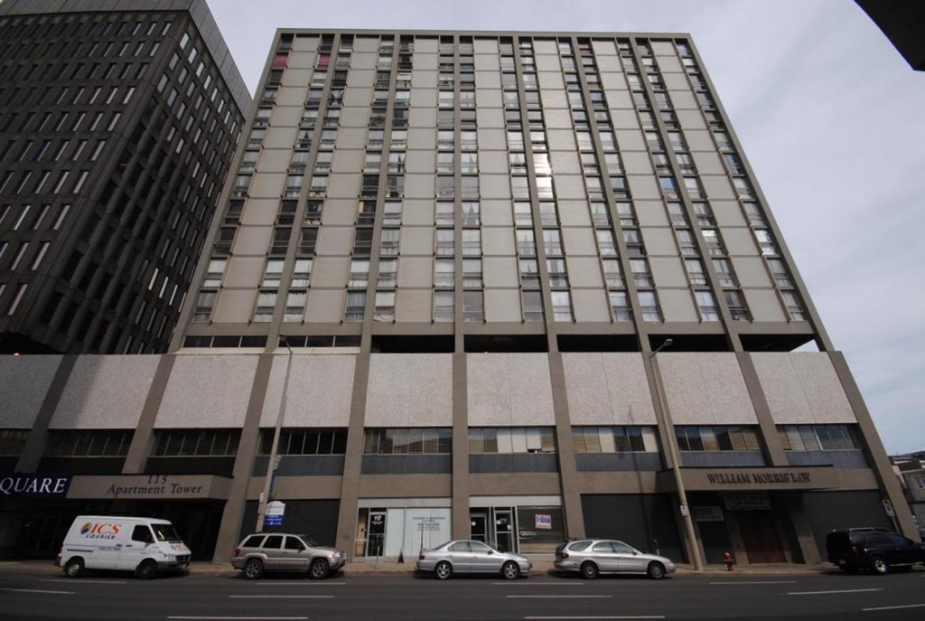 A tall building with a sign that says "William Morris Ltd" on the front.