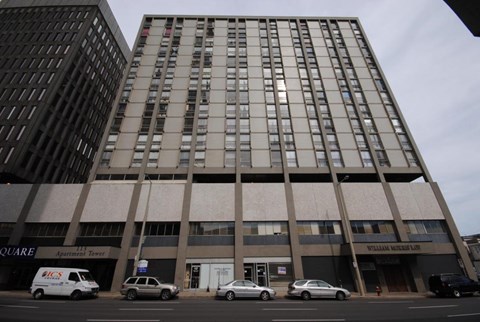 A tall building with a sign that says "William Morris Ltd" on the front.