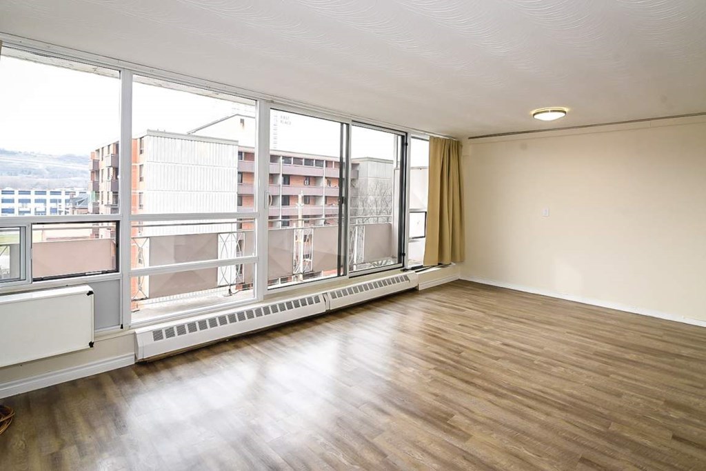 A room with a large window overlooking a cityscape.