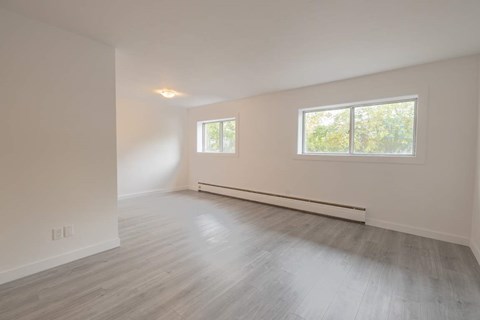 A room with a window and a long wall.