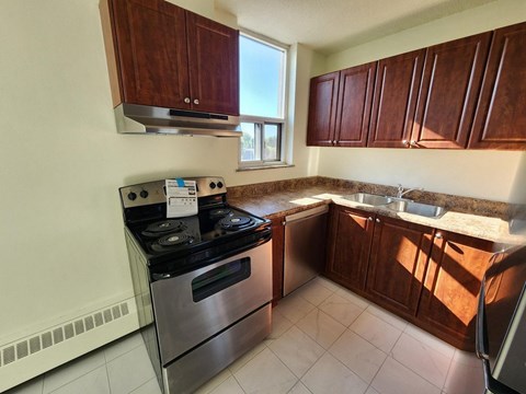 A kitchen with a stove and sink.