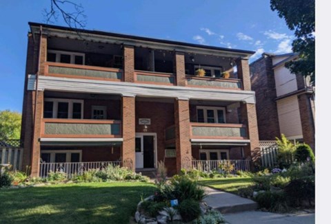 A large, old building with a balcony on the second floor.