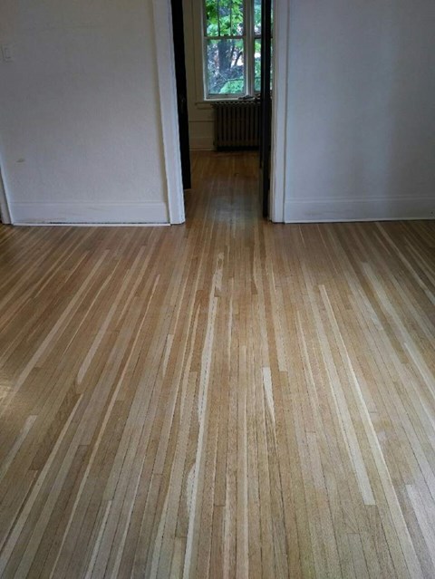 A room with a wooden floor and white walls.