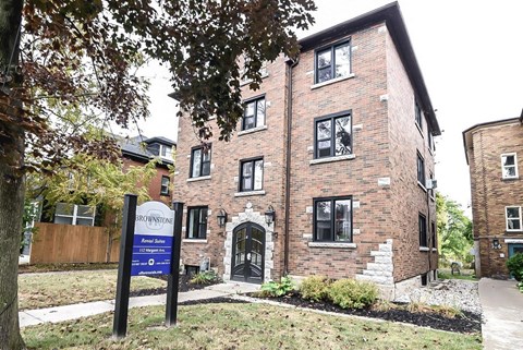 A brick building with a sign that says Brownstone.