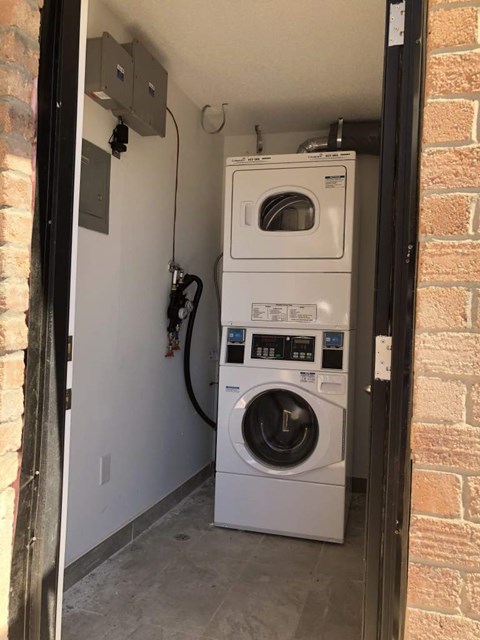 A white washer and dryer in a small utility room.