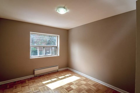 A room with a window and a bench.