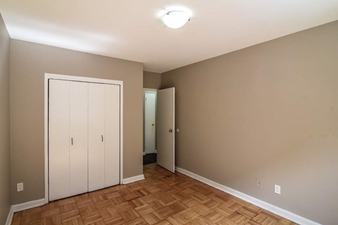 A room with a wooden floor and a white door.