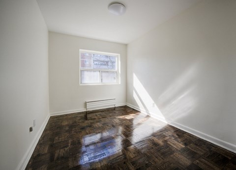 A room with a window and a radiator on the wall.