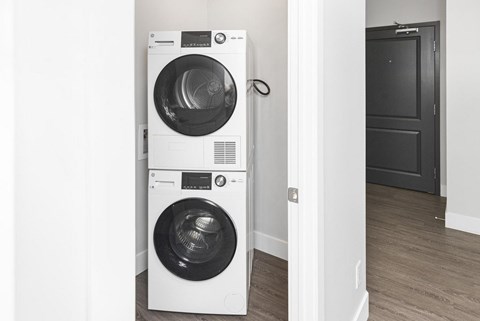 Two washing machines are stacked on top of each other.