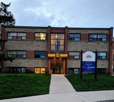 The Osler Court building is a modern structure with a brick facade and a welcoming entrance.