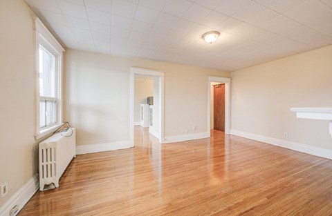 A room with wooden floors and white walls.