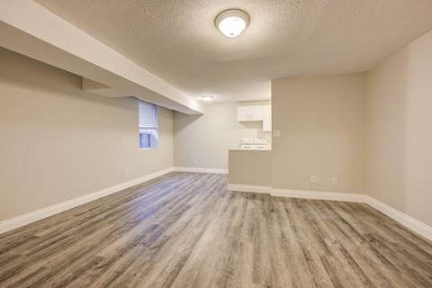 A room with wooden flooring and a window.