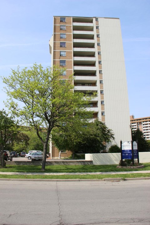 A tall building with a tree in front of it.