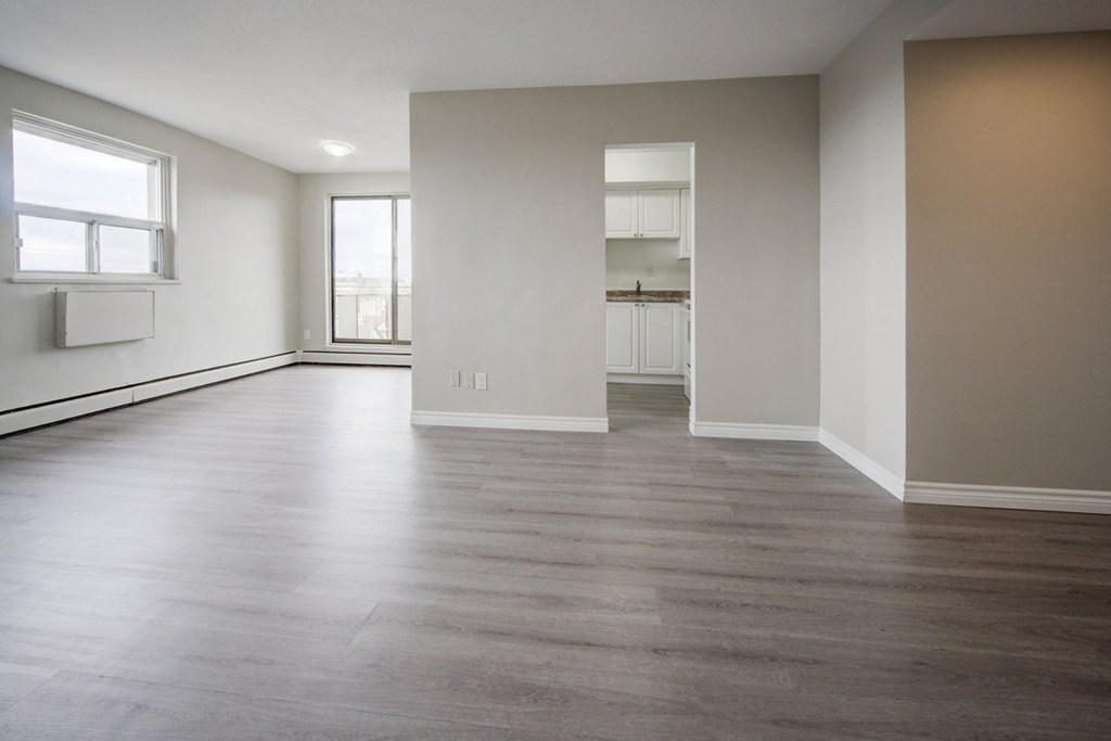 Empty room with wooden floors and white walls.