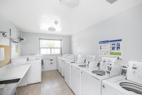 A laundry room with washers and dryers.