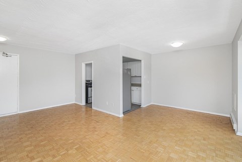 A room with a wooden floor and white walls.