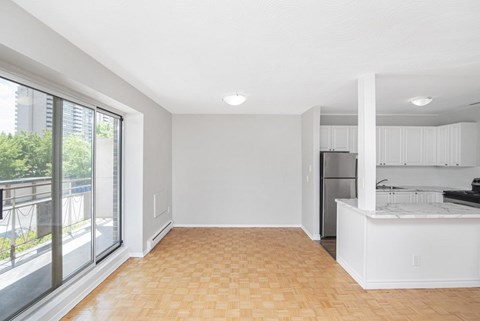 A kitchen with a white counter and a refrigerator.