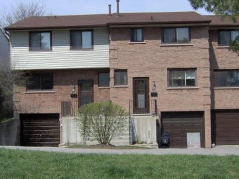 A brown brick house with a white garage door.