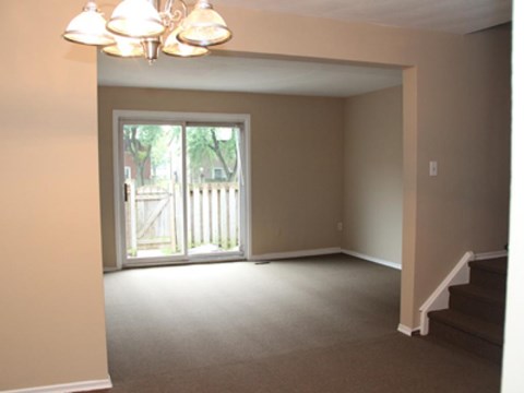 A room with a staircase and a chandelier.