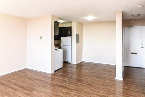 A kitchen area with a refrigerator and cabinets.