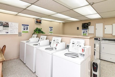 A row of washing machines in a laundromat.