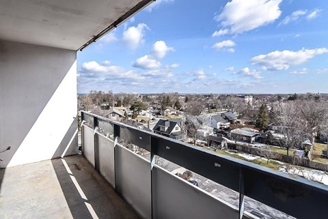 A balcony overlooks a residential neighborhood.