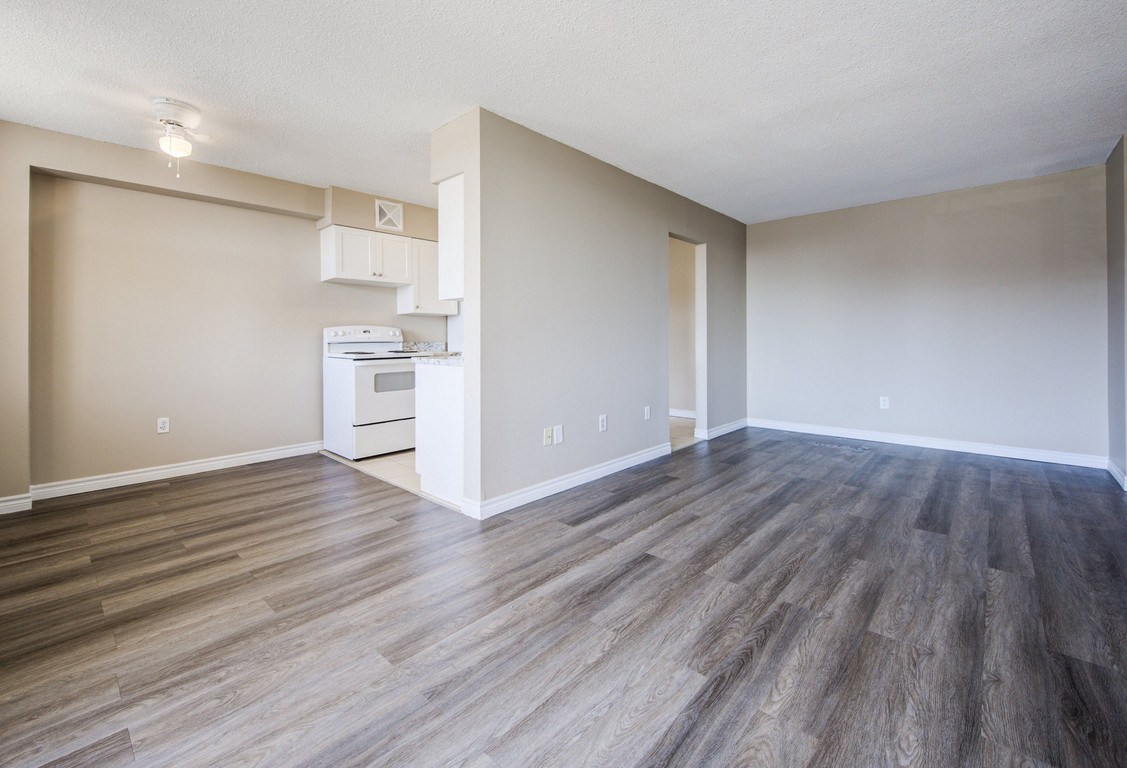 A kitchen area with a white oven and microwave.
