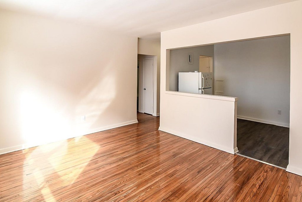 A room with wooden floors and white walls.