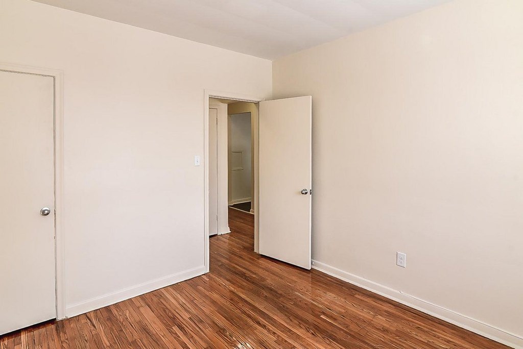 A room with a white door and a white closet door.