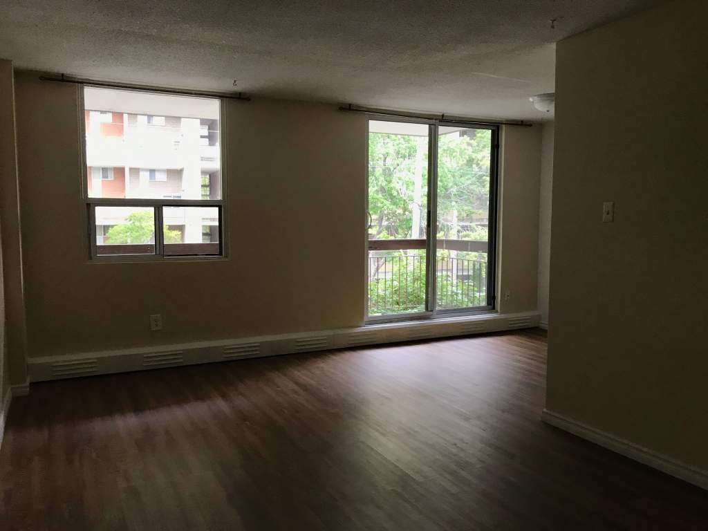 A room with a window and sliding glass doors.