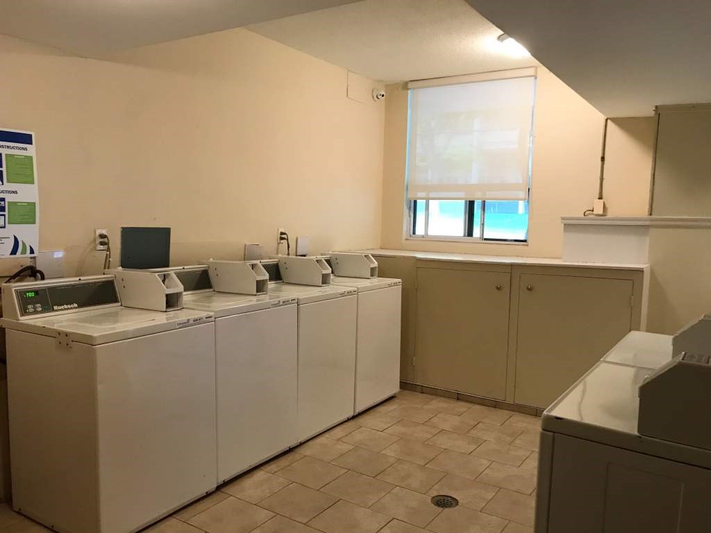 A row of washing machines in a laundromat.