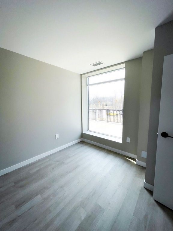 A room with a grey floor and a white door.