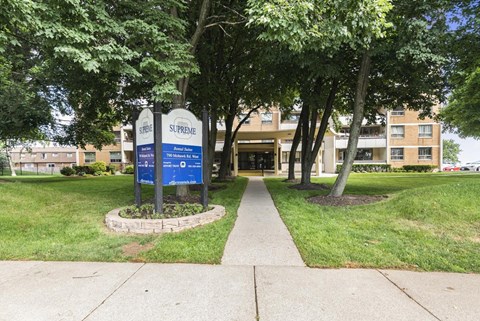 The Supreme sign is blue and white and is in front of a building.