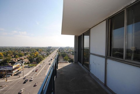 A view from a building looking out over a highway with cars on it.