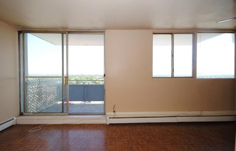 A room with a sliding glass door leading to a balcony.