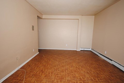 A room with a wooden floor and white walls.