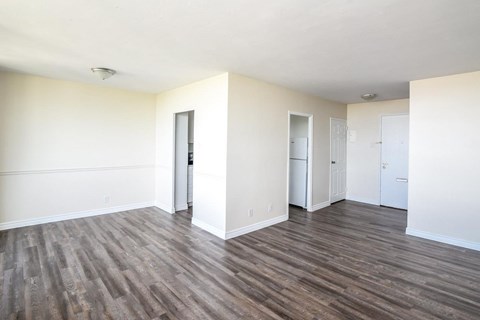 A room with wooden floors and white walls.