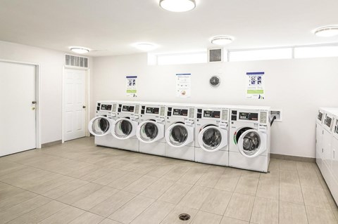 A row of washing machines in a laundromat.