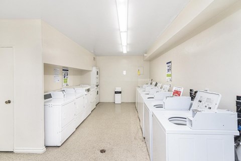 A laundry room with washers and dryers.
