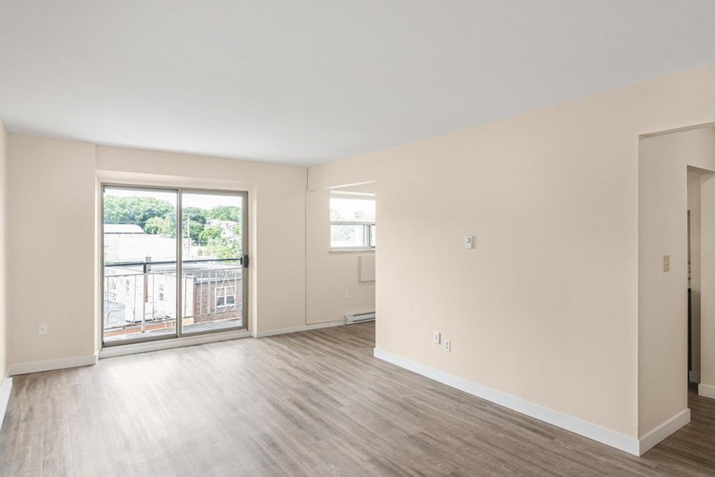 A large empty room with a sliding glass door.