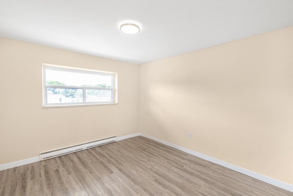 A room with a window and a white ceiling.