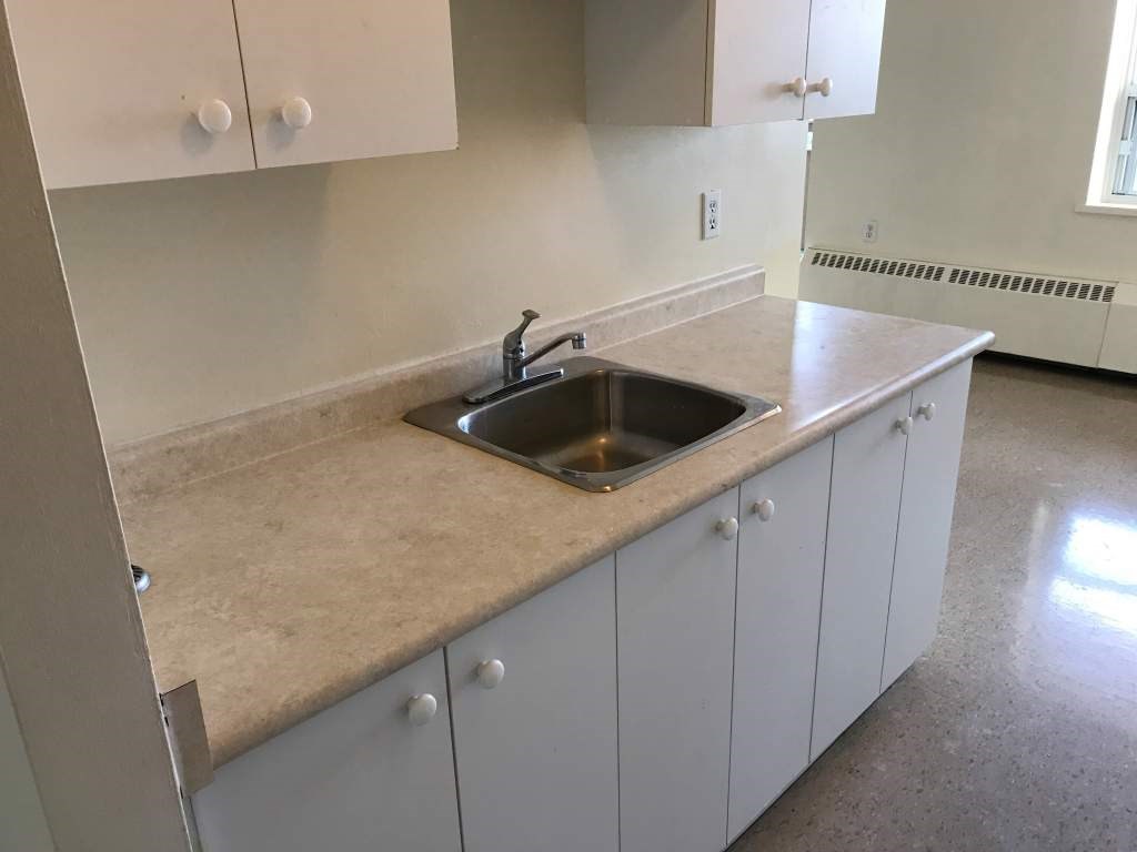 A kitchen with a sink and cabinets.